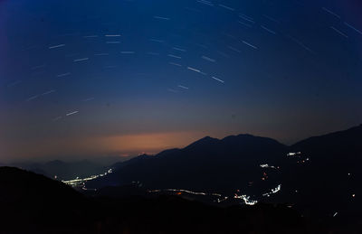 Scenic view of silhouette mountains against sky at night