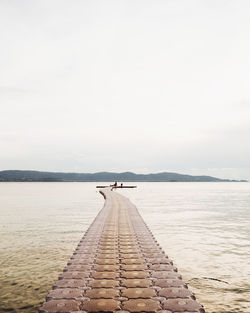 Pier over sea against sky