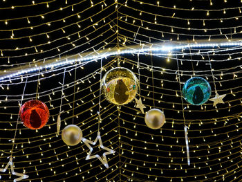 Low angle view of illuminated lights hanging on ceiling
