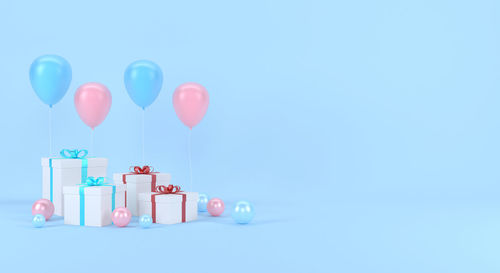 Multi colored balloons against blue background