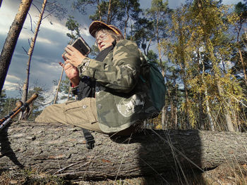 Rear view of man standing in forest