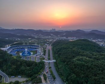 High angle view of road by buildings against sky during sunset