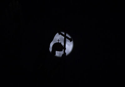 Low angle view of illuminated light against sky at night