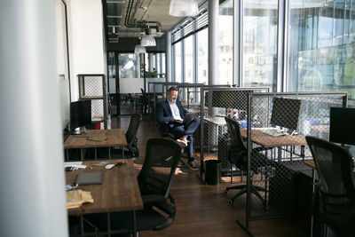 Businessman working on laptop at office cubicle