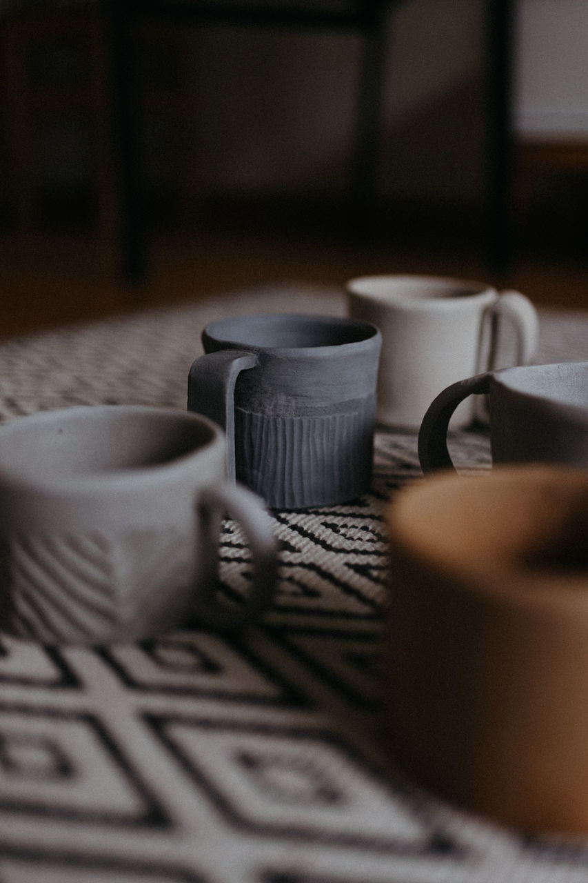 CLOSE-UP OF COFFEE CUP ON TABLE AT HOME