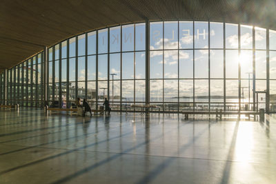 People at airport seen through glass window