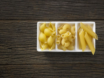 Close-up of colorful fusilli pasta in container on table