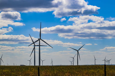 Windmill on field against sky