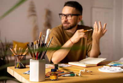 Portrait of young man working at table