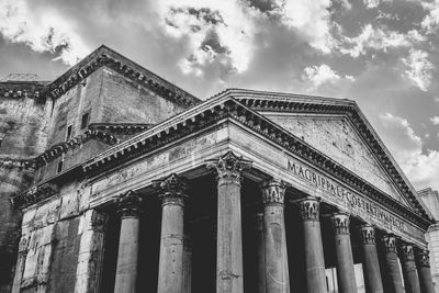 Low angle view of historical building against cloudy sky