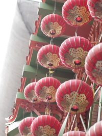 Low angle view of lanterns hanging on pink flowers