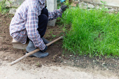 Rear view of man working on field