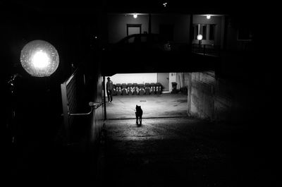 Man walking in illuminated corridor