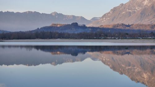 Scenic view of lake and mountains against sky