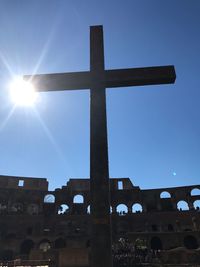 Low angle view of cross against blue sky