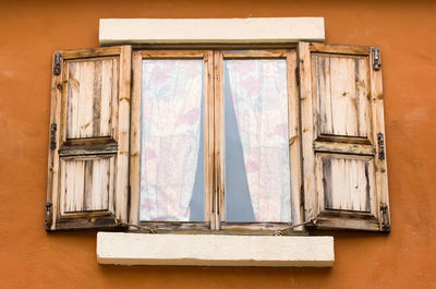 Close-up of window on wooden wall