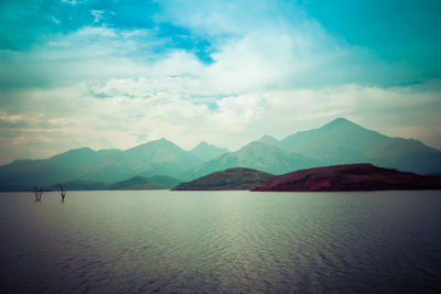 Scenic view of lake and mountains against sky