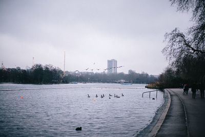 Scenic view of lake in city against sky