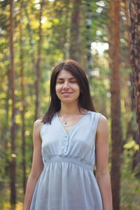 Portrait of a beautiful young woman in forest