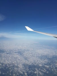Cropped image of airplane flying over landscape