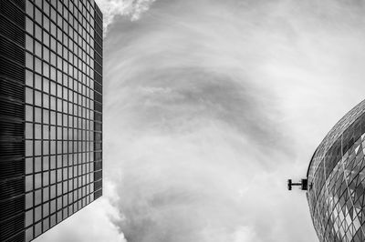 Low angle view of modern buildings in city against sky