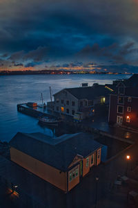 High angle view of illuminated sea against sky at sunset