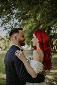 Wedding day. happy bride and groom hugging and laughing red hair diversity