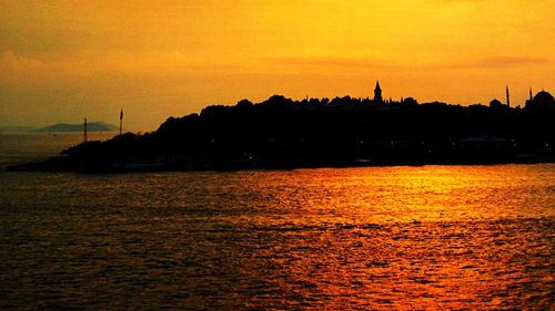 Scenic view of river at sunset