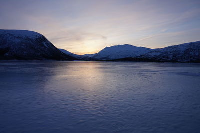 Scenic view of lake against sky during sunset