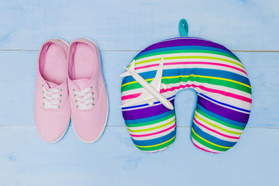 Directly above shot of neck pillow with shoes and model airplane on table