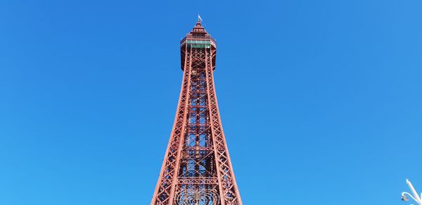 Low angle view of communications tower against blue sky