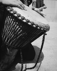 Midsection of man playing drum on road