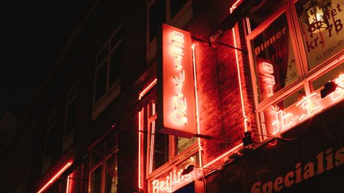 Low angle view of illuminated text at night