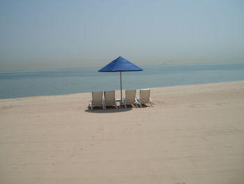 Lifeguard hut on beach against clear sky