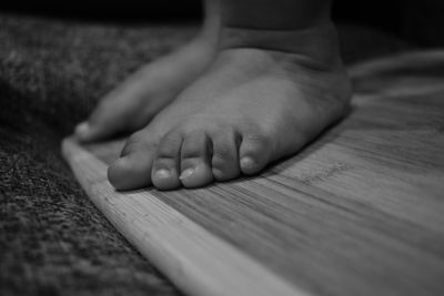 Low section of baby feet on wood