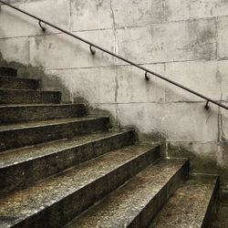 Handrail on wall by stairway