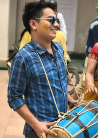 Portrait of smiling man holding sunglasses