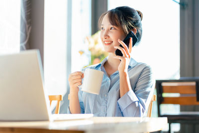 Businesswoman using laptop at office