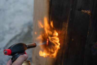 Midsection of person holding fire against blurred background