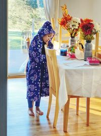 Portrait of child standing in dining room