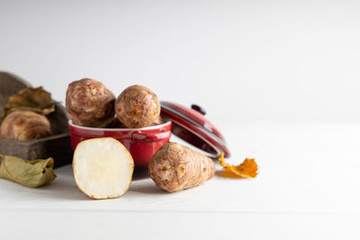 Close-up of fruits on table against white background
