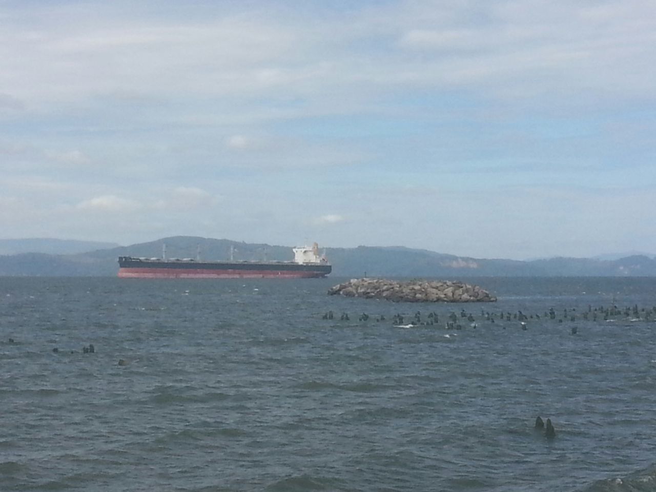 BOAT IN SEA AGAINST SKY