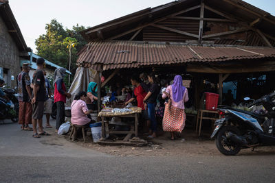 People at market stall in city