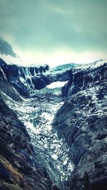 Scenic view of snow covered mountains against sky