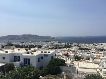 High angle view of townscape and bay against sky