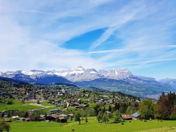 Scenic view of field and mountains against sky