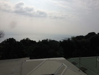 High angle view of trees by sea against sky