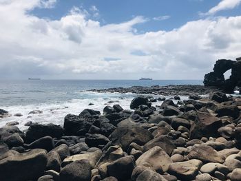 Rocks on beach against sky