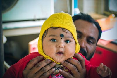 Close-up portrait of cute baby eating