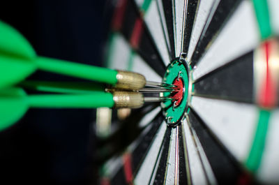 Close-up of green darts on target